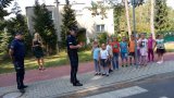 Policjanci pokazują maluchom jak przechodzić przez przejście