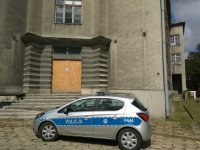 Radiowóz pod budynkiem, w którym wandale wybijali szyby