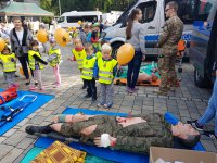 Ratownicy i dzieci na stanowisku udzielania pierwszej pomocy
