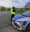 Na zdjęciu policjant na drodze w trakcie kontroli prędkości.