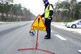 Na zdjęciu policjant w trakcie czynności na miejscu wypadku.