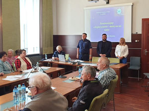 Na zdjęciu I Zastępca Komendanta Powiatowego Policji w Lublińcu, Burmistrz Woźnik, i Zastępca Burmistrza Woźnik siedzący przy stole w trakcie debaty w Woźnikach.