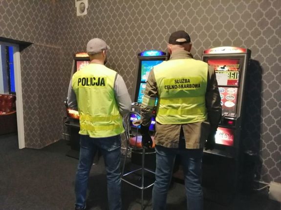 Na zdjęciu widoczni policjanci oraz automaty do nielegalnych gier hazardowych.