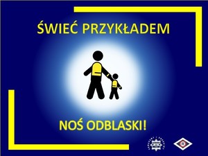 na zdjęciu widoczny jest plakat z napisem świeć przykładem widać na nim dużego ludzika i małego ludzika świecącego się jasnym światłem koloru żółtego