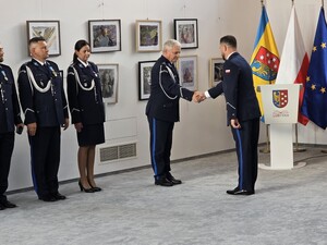 czterech umundurowanych policjantów dwóch z nich podaje sobie dłonie